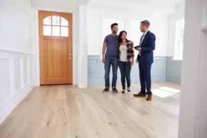 Realtor showing couple around new home